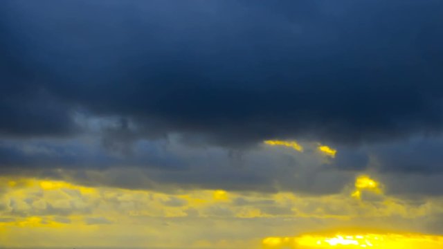 Dark and dramatic storm cloud area background. Time Lapse. Epic storm tropical clouds at sunset. Coast of the Pacific Ocean. Palm beach. Timelapse 4K UHD.