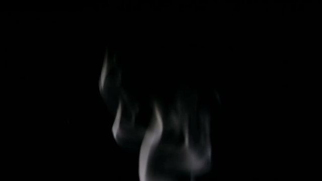 White Steam Rises from up. White smoke over a black background. Smoke slowly floating through space against black background. 4K UHD