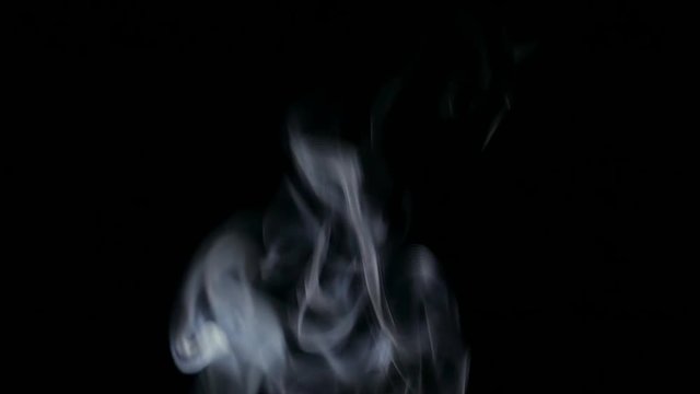 White Steam Rises from up. White smoke over a black background. Smoke slowly floating through space against black background. 4K UHD