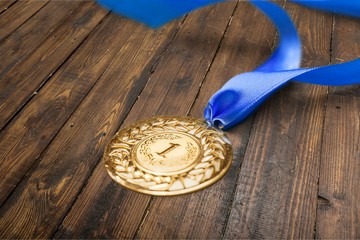 Gold medal with  ribbon  on  background