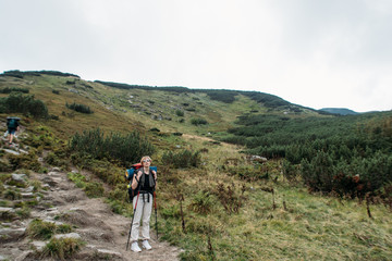 Fototapeta na wymiar woman goes hiking with a backpack, mountains, nature, travel