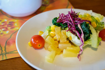 Delicious salad served on a white plate, food concept.