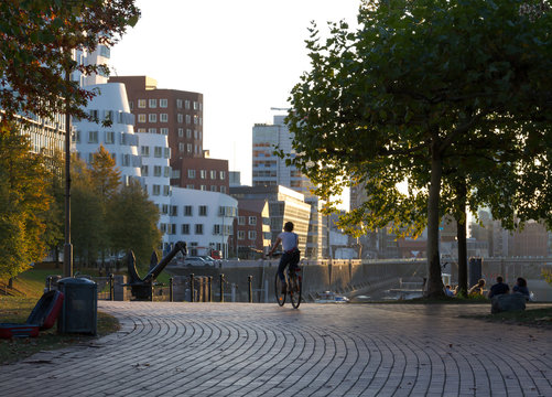 person riding bycicle in warm autumn day in D&uuml;sseldorf