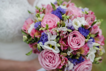 bride holds a bouquet, the bride's bouquet, wedding day, bride in a wedding dress