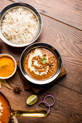 Dal makhani / makhni is a popular dish from India. Made with ingredients like whole black lentil, butter and cream. Served with Naan/roti and rice