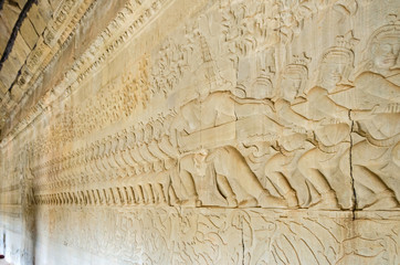 The wall of one of the galleries of Angkor Wat with bas-reliefs showing asuras and devas
