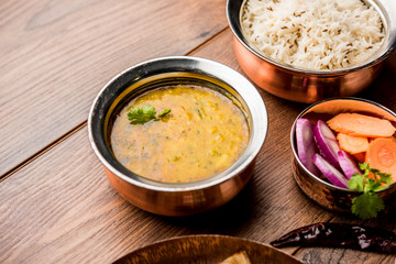 Dal Tadka Fry / Indian Lentil Curry served in a bowl with rice and roti, selective focus