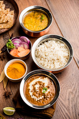 Indian Lunch / Dinner main course food in group includes Paneer Butter Masala, Dal Makhani, Palak Paneer, Roti, Rice etc, Selective focus