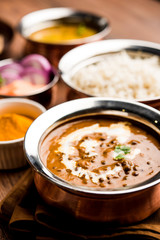 Dal makhani / makhni is a popular dish from India. Made with ingredients like whole black lentil, butter and cream. Served with Naan/roti and rice