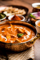 Paneer Butter Masala or Cheese Cottage Curry in serving a bowl or pan, served with or without roti and rice