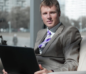 Business man working at office with laptop on his desk.