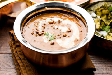 Dal makhani / makhni is a popular dish from India. Made with ingredients like whole black lentil, butter and cream. Served with Naan/roti and rice