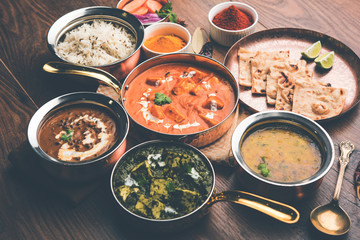Indian Lunch / Dinner main course food in group includes Paneer Butter Masala, Dal Makhani, Palak Paneer, Roti, Rice etc, Selective focus