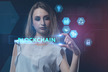 The concept of business, technology, the Internet and the network. A young entrepreneur working on a virtual screen of the future and sees the inscription: blockchain