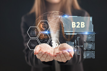 The concept of business, technology, the Internet and the network. A young entrepreneur working on a virtual screen of the future and sees the inscription: B2B