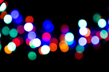 The colorful bokeh on the blurred natural black background.