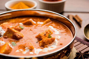 Paneer Butter Masala or Cheese Cottage Curry in serving a bowl or pan, served with or without roti and rice