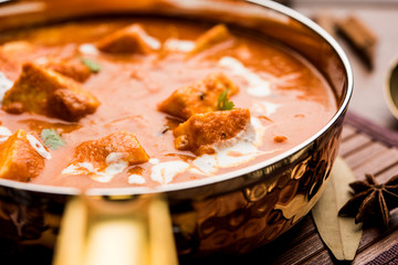 Paneer Butter Masala or Cheese Cottage Curry in serving a bowl or pan, served with or without roti and rice