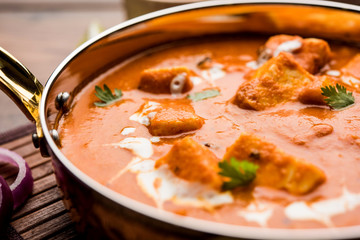 Paneer Butter Masala or Cheese Cottage Curry in serving a bowl or pan, served with or without roti and rice