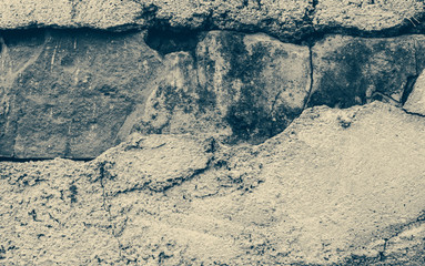 Broken brick concrete wall monochrome vintage background closeup image