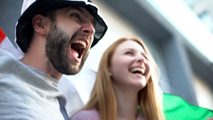 Football supporters chanting, rejoicing victory of national team, championship