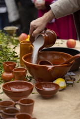 A man is preparing queimada (traditional Galician hot drink made with flamed 