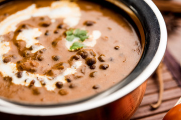 Dal makhani / makhni is a popular dish from India. Made with ingredients like whole black lentil, butter and cream. Served with Naan/roti and rice