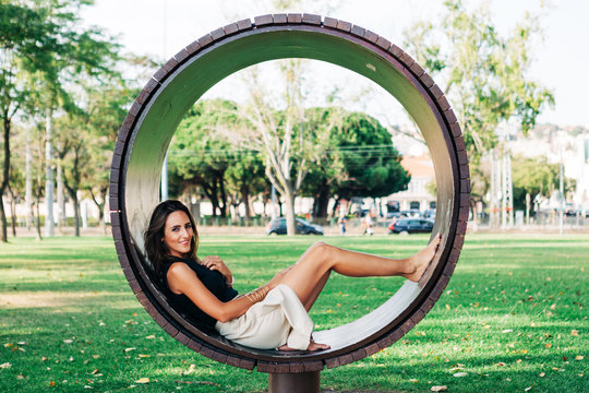 Brunette sitting in modern round bench