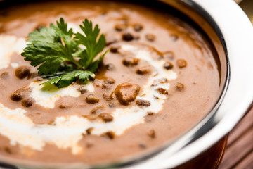 Dal makhani / makhni is a popular dish from India. Made with ingredients like whole black lentil, butter and cream. Served with Naan/roti and rice
