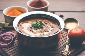 Dal makhani / makhni is a popular dish from India. Made with ingredients like whole black lentil, butter and cream. Served with Naan/roti and rice