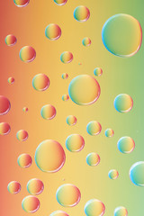 close-up view of beautiful calm transparent water drops on colorful abstract background