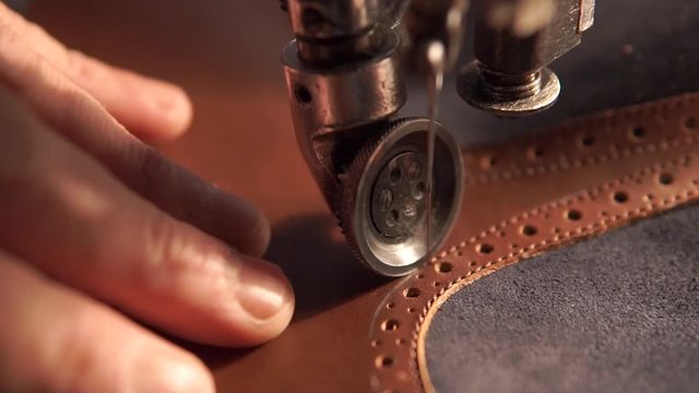sewing machine and red leather with a seam close-up. sewing process.