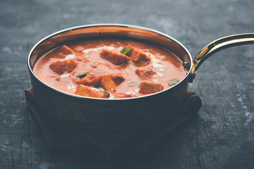 Paneer Butter Masala or Cheese Cottage Curry in serving a bowl or pan, served with or without roti and rice