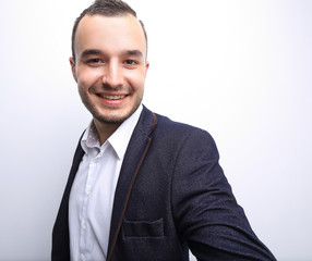 Happy successful businessman pointing on copy space