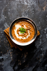 Dal makhani / makhni is a popular dish from India. Made with ingredients like whole black lentil, butter and cream. Served with Naan/roti and rice