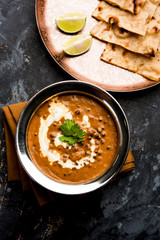 Dal makhani / makhni is a popular dish from India. Made with ingredients like whole black lentil, butter and cream. Served with Naan/roti and rice