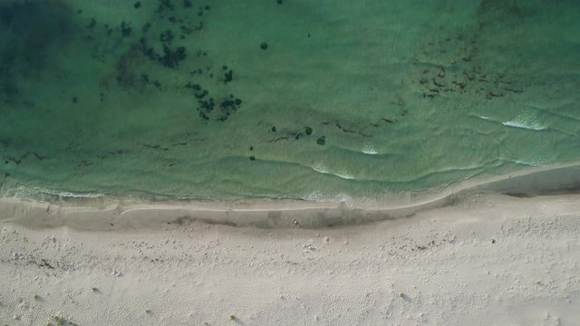 Beautiful aerial view of ocean waves and a sandy beach in southern Sweden.