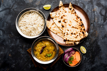 Dal Tadka Fry / Indian Lentil Curry served in a bowl with rice and roti, selective focus