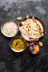 Dal Tadka Fry / Indian Lentil Curry served in a bowl with rice and roti, selective focus
