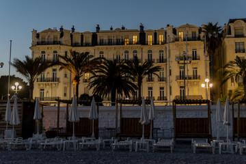 Night shot of a historic and beautifully decorated facade of a building in Nice, France.