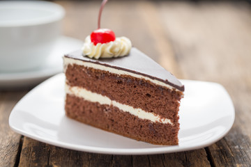 chocolate cake slice on plate on wooden table