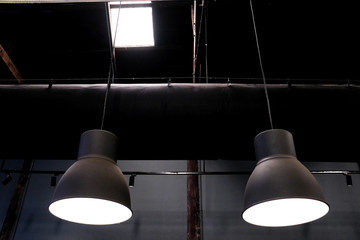 Loft industrial ceiling lamp hanging from a warehouse roof