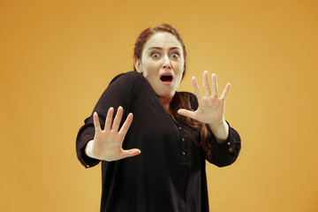 I'm afraid. Fright. Portrait of the scared woman. Business woman standing isolated on trendy studio...