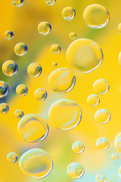 beautiful calm clean water drops on yellow abstract background