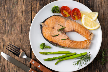 Salmon Grilled on a white plate on wooden table