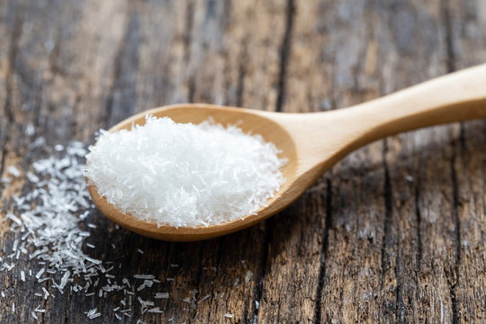 monosodium glutamate, MSG on wooden spoon