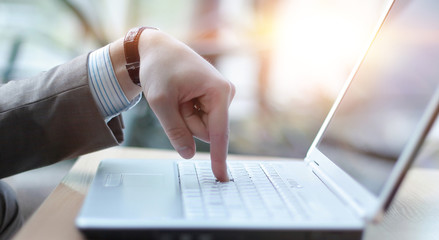 Touch of a finger to the laptop computer keyboard, side view