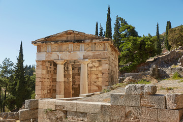 Fototapeta na wymiar The Athenian treasury in Delphi, Greece in a summer day.