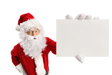 Surprised Santa Claus holding a blank card