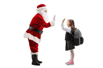 Santa Claus high-fiving a schoolgirl